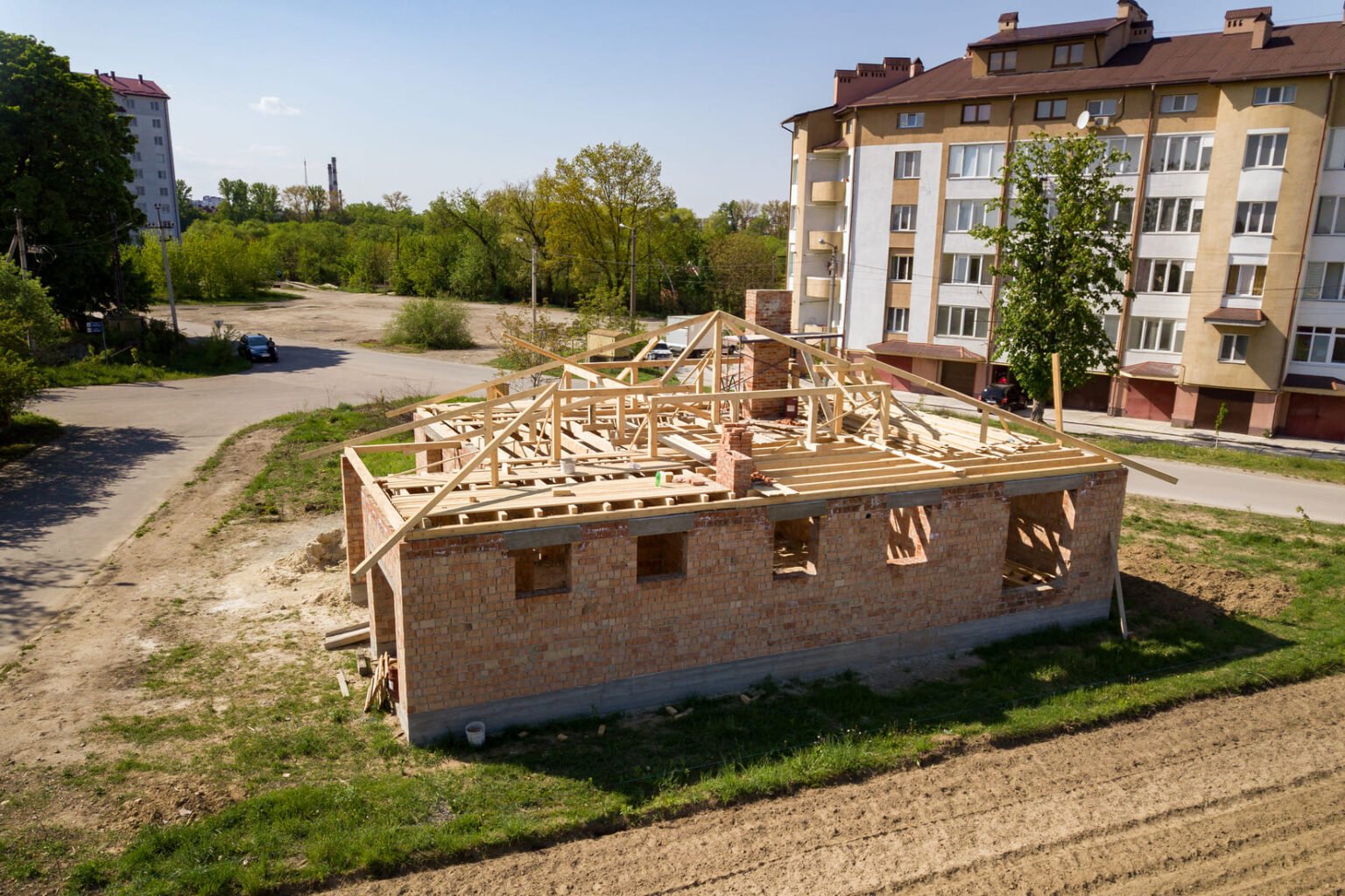 aerial-view-of-unfinished-brick-house-with-wooden-2024-12-06-19-55-03-utc