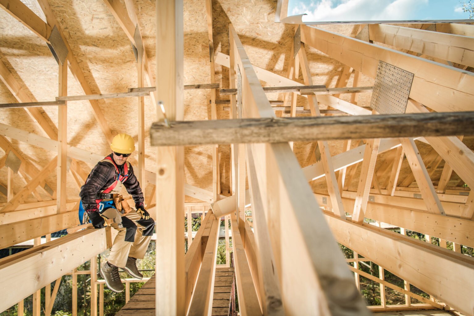 construction-worker-sitting-on-a-wooden-roof-beam-2023-11-27-05-33-56-utc